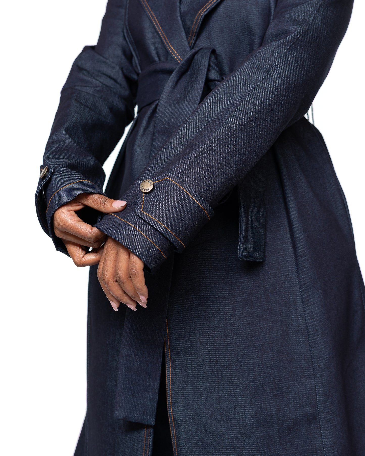 Women’s dark wash denim trench coat with belted waist and longline cut, stylish outerwear fashion Kenya.