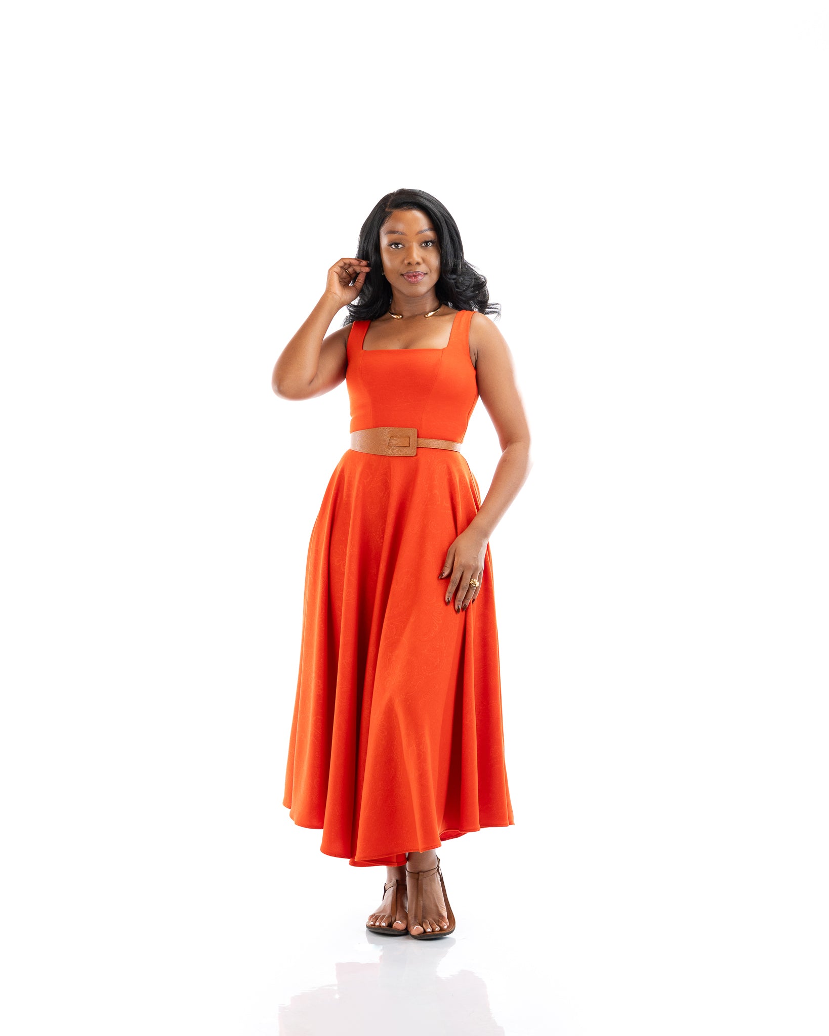 Orange sleeveless belted midi dress with square neckline and flowy skirt, women’s elegant fashion in Kenya.