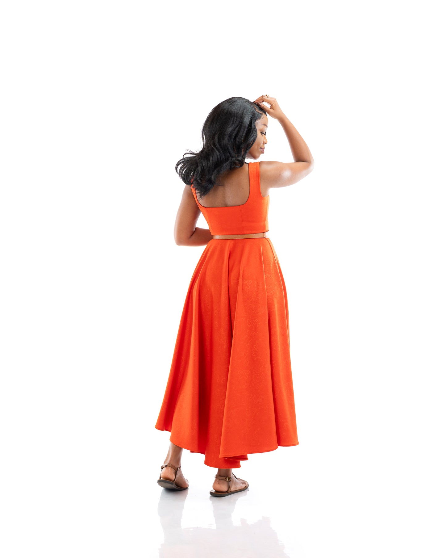 Orange sleeveless belted midi dress with square neckline and flowy skirt, women’s elegant fashion in Kenya.